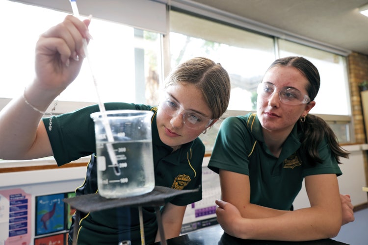 students using science equipment