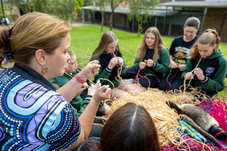 students gathered in a yarning circle